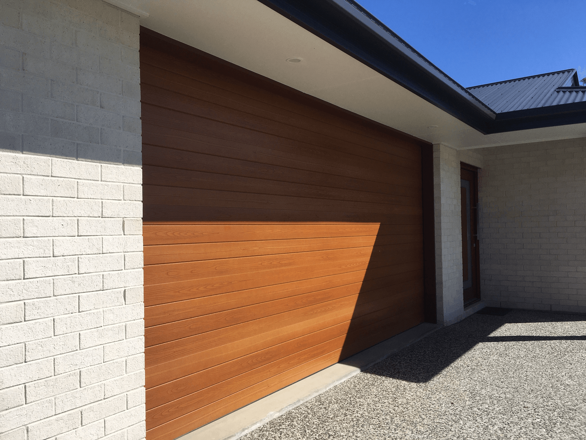Salt brick from PGH in Zen by Nature range up close against timber garage door