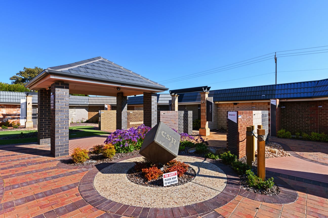 PGH Selection Centre with samples and product info on the wall and customers at a table with a service agent.