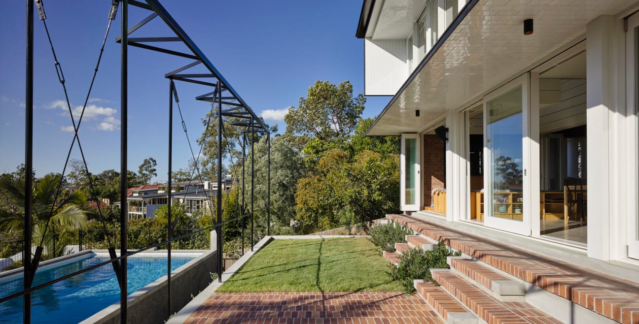 Vokes and Peters use PGH Copper Glow bricks on modern residential home to connect brick and land in St Lucia, Brisbane.