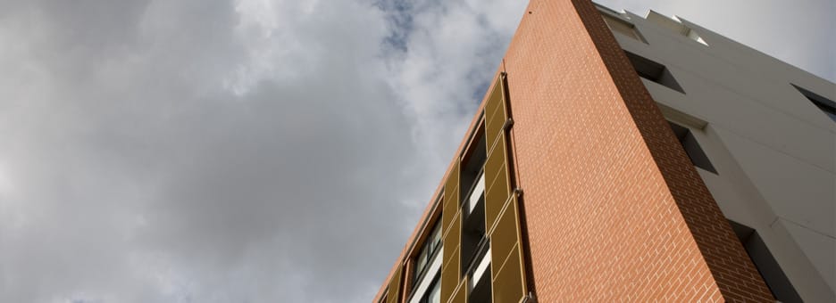 Morada dark brick behind chair and table setting.