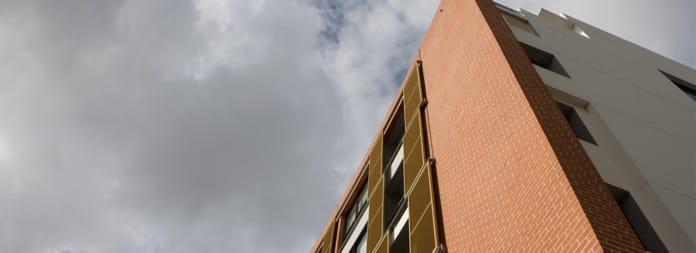 Morada dark brick behind chair and table setting.
