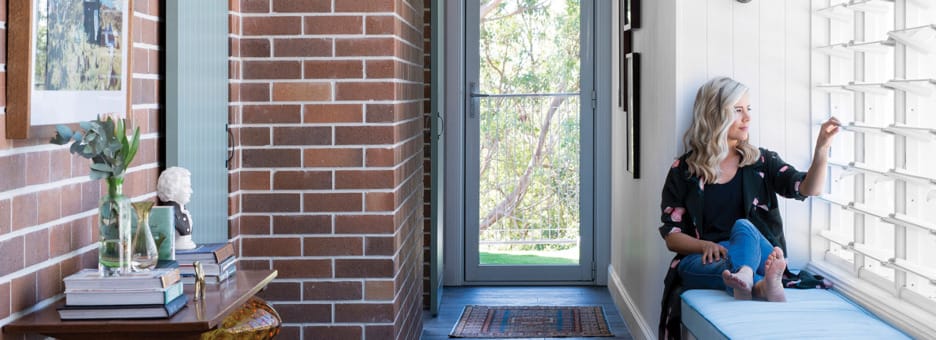 Dry Pressed Architecture brick wall with woman on a daybed looking out the window.