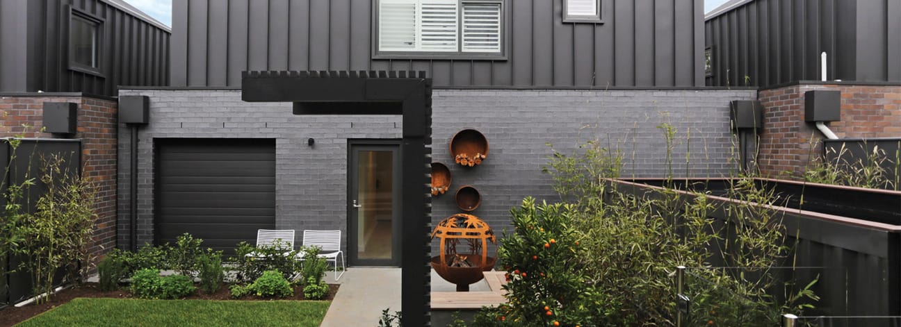 Morada dark brick behind chair and table setting.