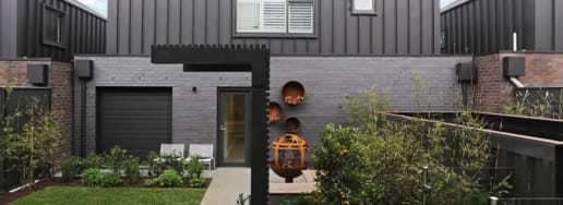 Morada dark brick behind chair and table setting.