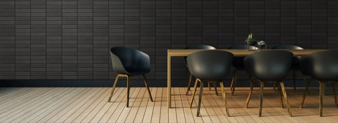 Morada dark brick behind chair and table setting.
