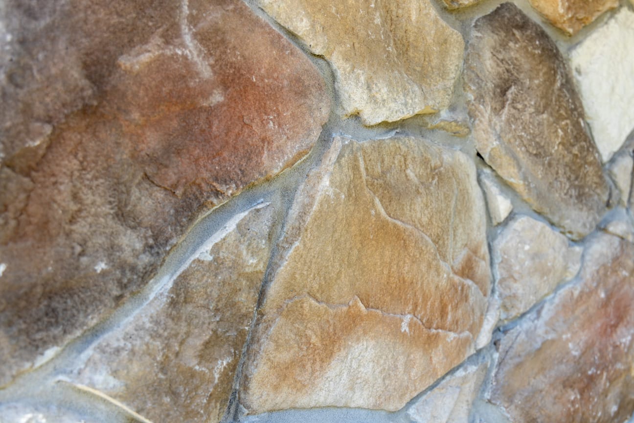 PGH Stone Natural Fieldstone Range in Russet installed on a wall with mortar