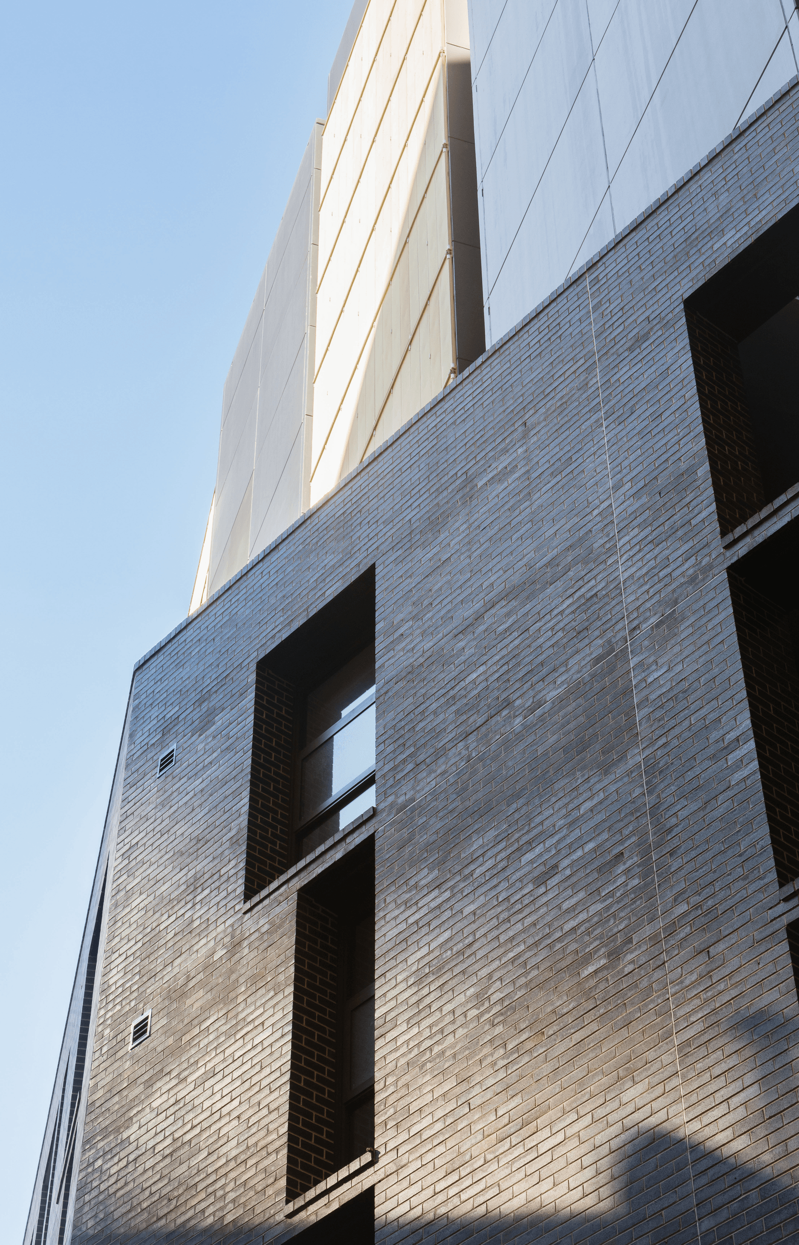 Tzannes uses PGH Mowbray Blue, Dry Pressed Architectural bricks to add a striking new addition to Sydney’s Day Street Apartments.