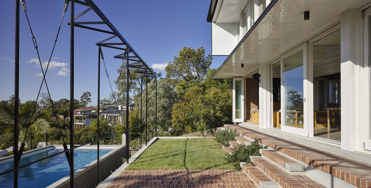Vokes and Peters use PGH Copper Glow bricks on modern residential home to connect brick and land in St Lucia, Brisbane.