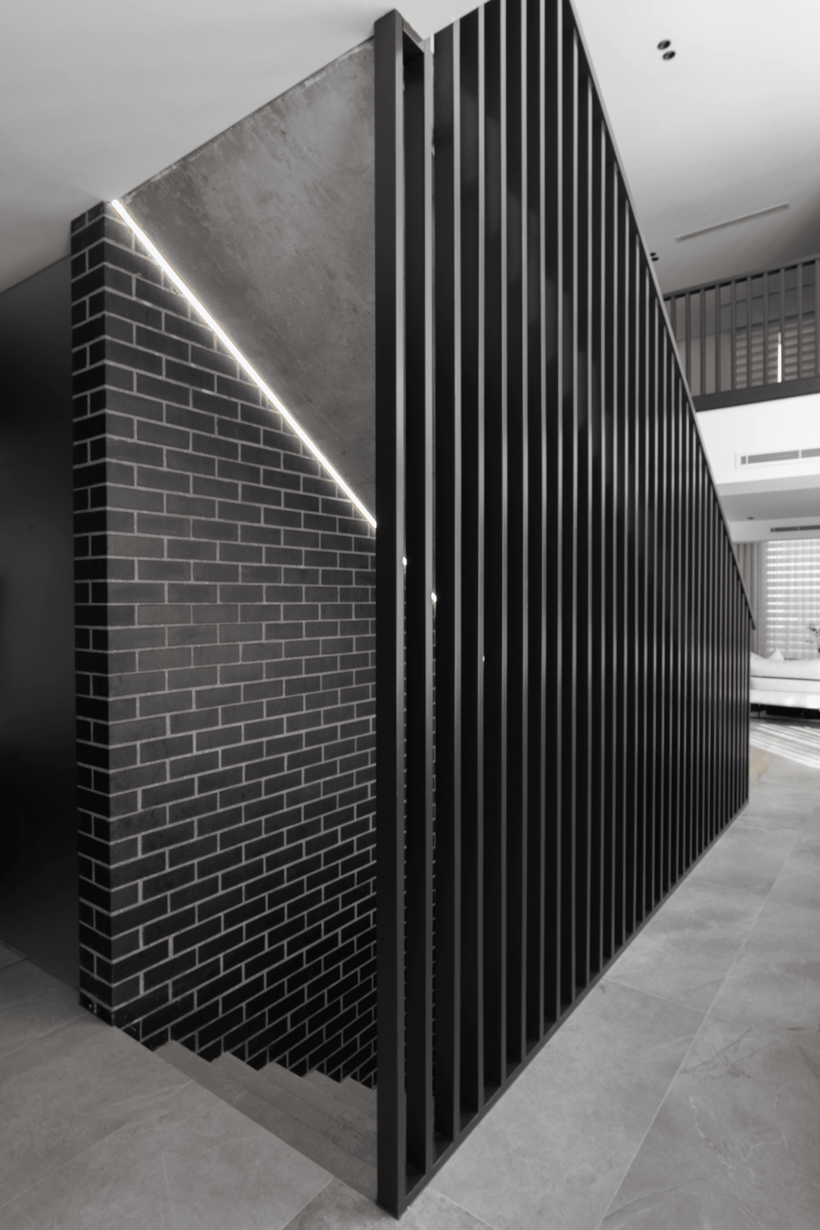 Nero Satin brick from PGH in Morada range internal staircase feature wall